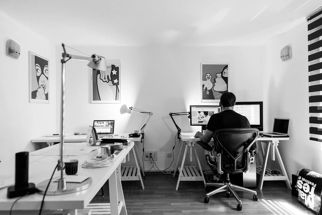 financial advisor reviewing compliance documents at a home office desk