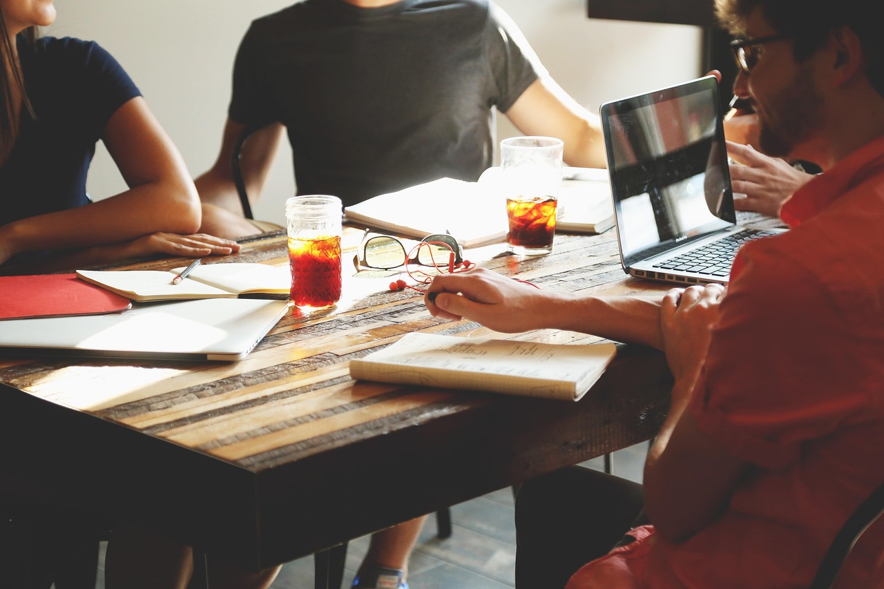 financial advisor reviewing transition documents with legal counsel at a conference table