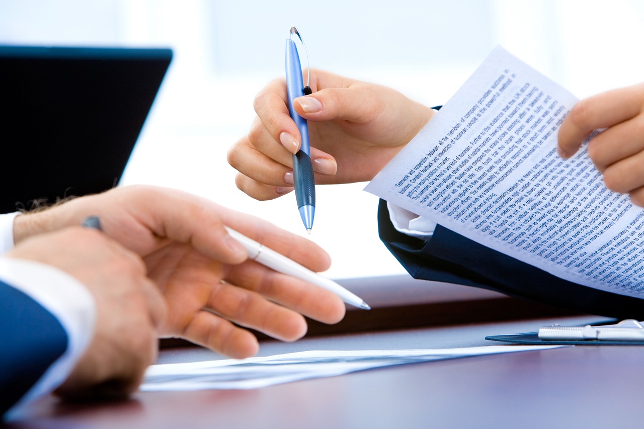 financial advisor and consultant reviewing a broker dealer transition plan on a laptop